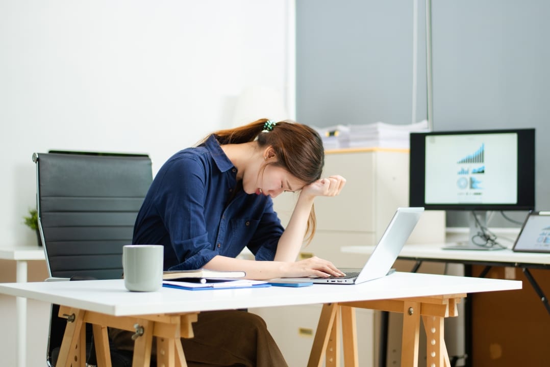 Person struggling with work tasks and cognitive performance due to environmental health issues