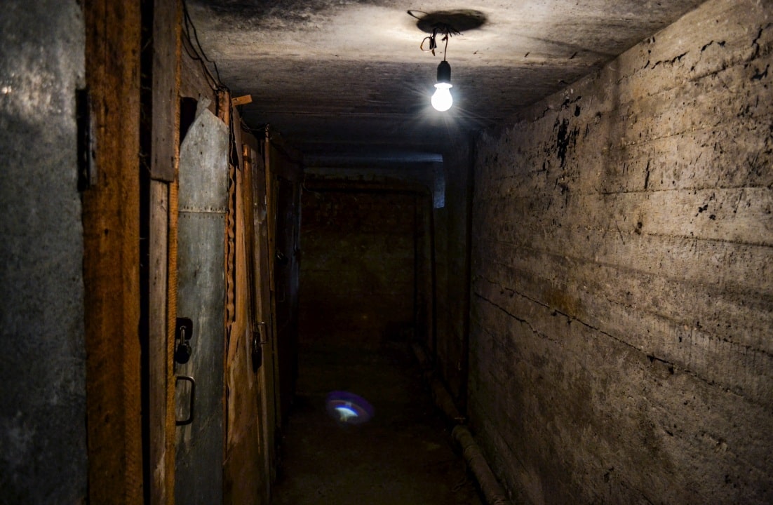 Professional workers installing crawlspace encapsulation system and vapor barriers
