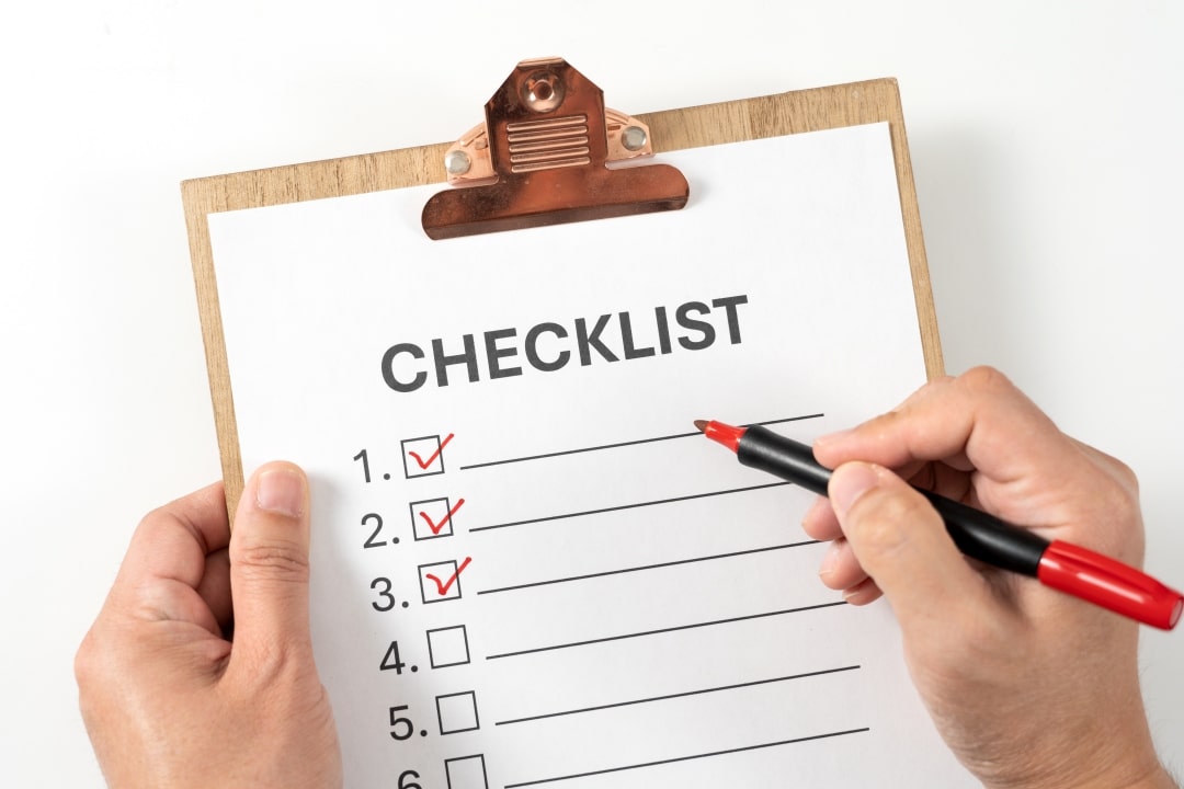 Professional homeowner conducting seasonal maintenance inspection with checklist and tools