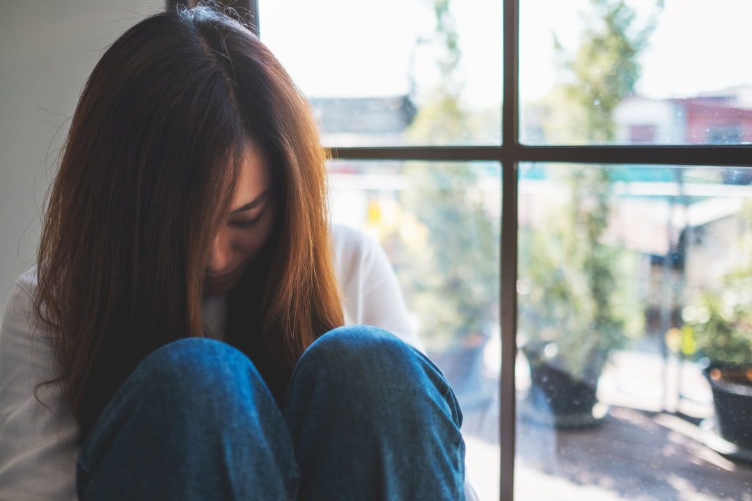 Person showing signs of depression and anxiety related to environmental health issues